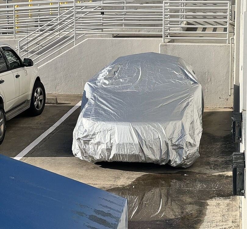 Anthony V.'s vehicle under its cover, from their review.