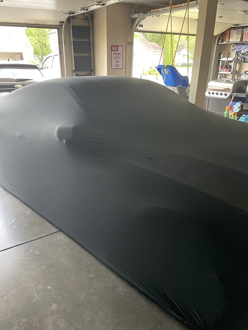 Aaron J.'s vehicle under its cover, from their review.