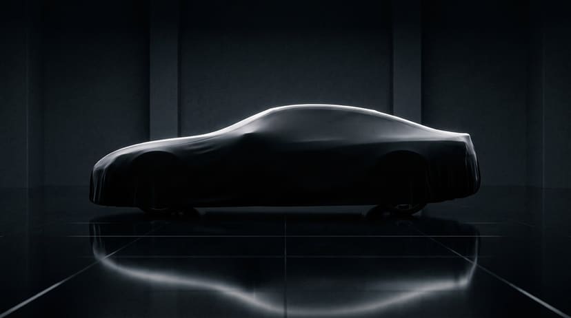 A car under a black stretch cover in profile in a dark studio, a thin line of light along its roof, reflected in a glossy floor.