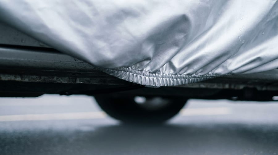The hem of a fitted cover at the wheel