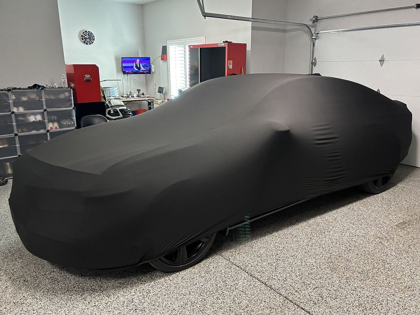 A customer's garage-kept car under its CarCovers cover
