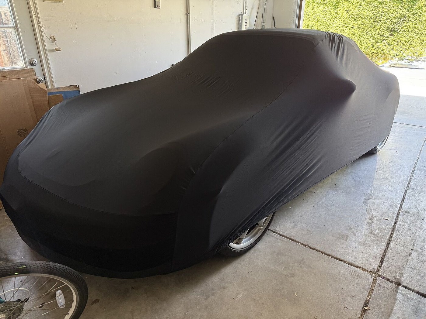 A customer's garage-kept car under its CarCovers cover