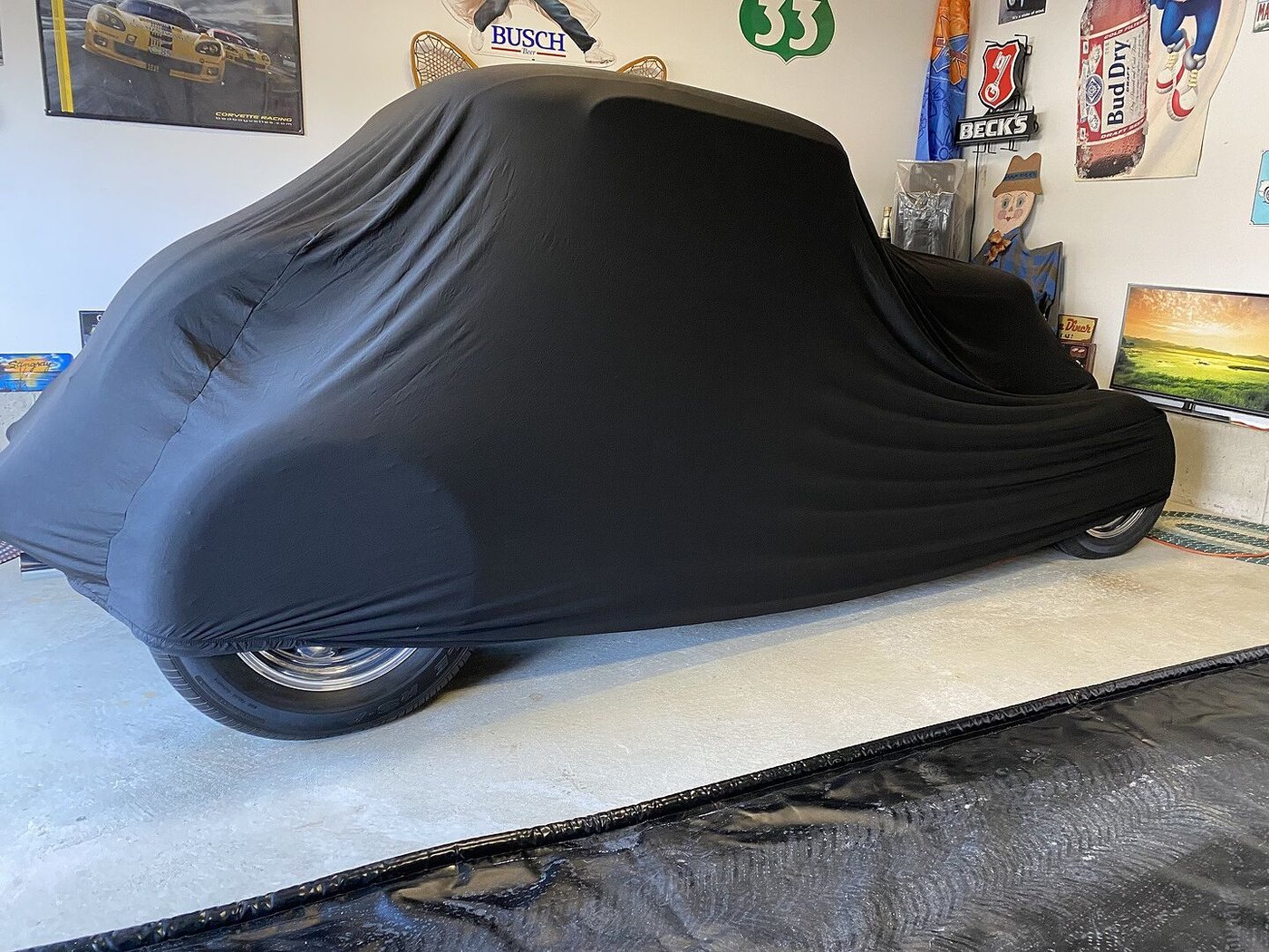 A customer's garage-kept car under its CarCovers cover