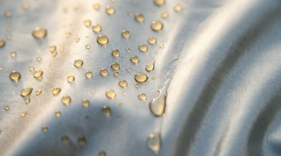 Macro of water beading up on the coated cover fabric, backlit